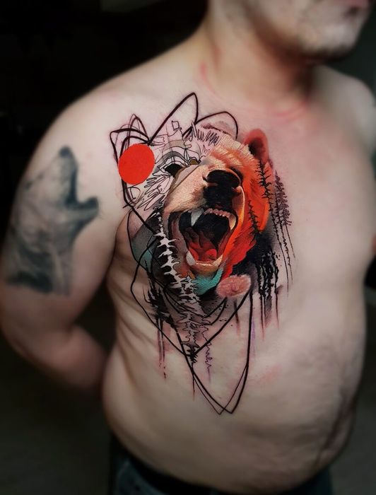 A man has a tattoo of a bear on his chest