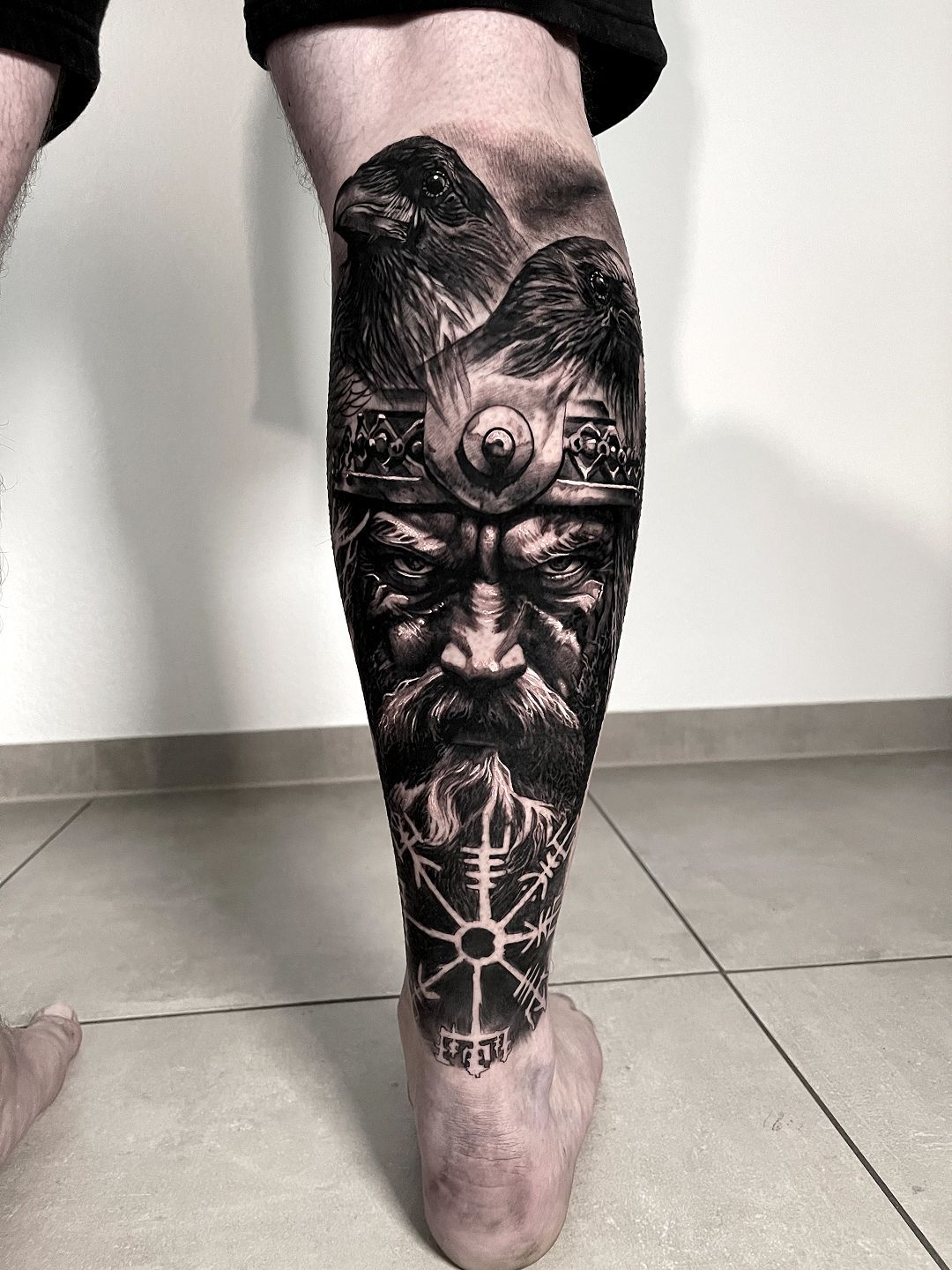 A person with a tattoo on their leg.