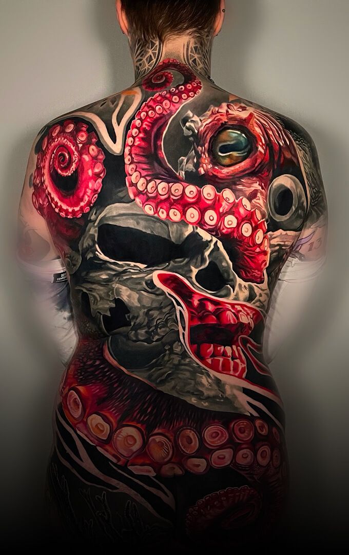 A woman has a full back tattoo of an octopus and a skull.