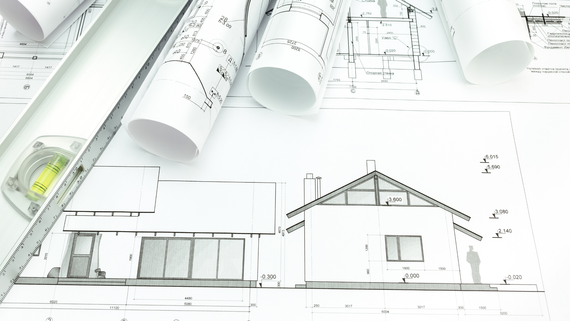 A black and white drawing of a house with a ruler on top of it.