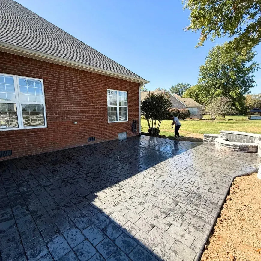A concrete driveway is being built in front of a house.