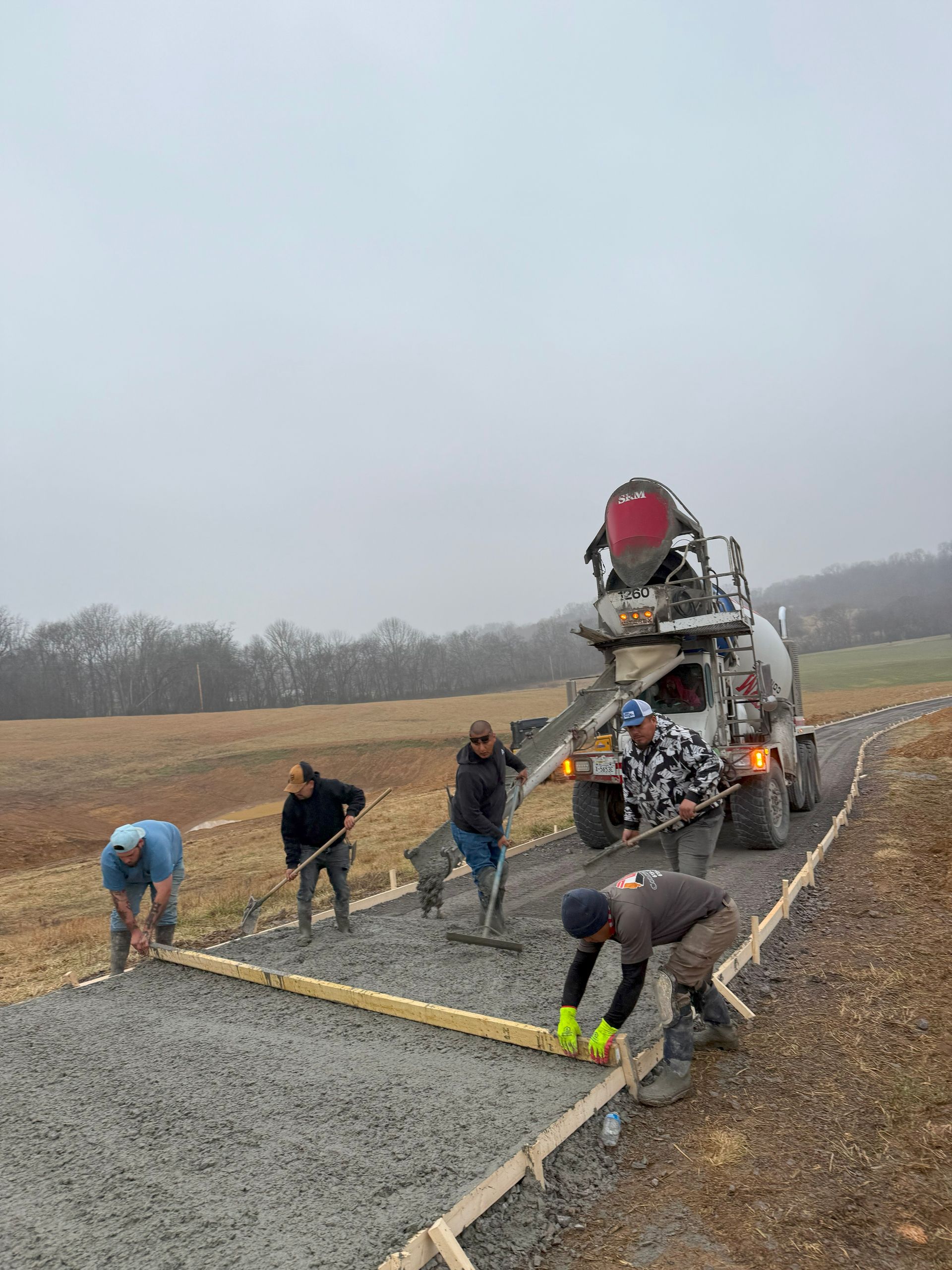 A group of construction workers are working on a road.