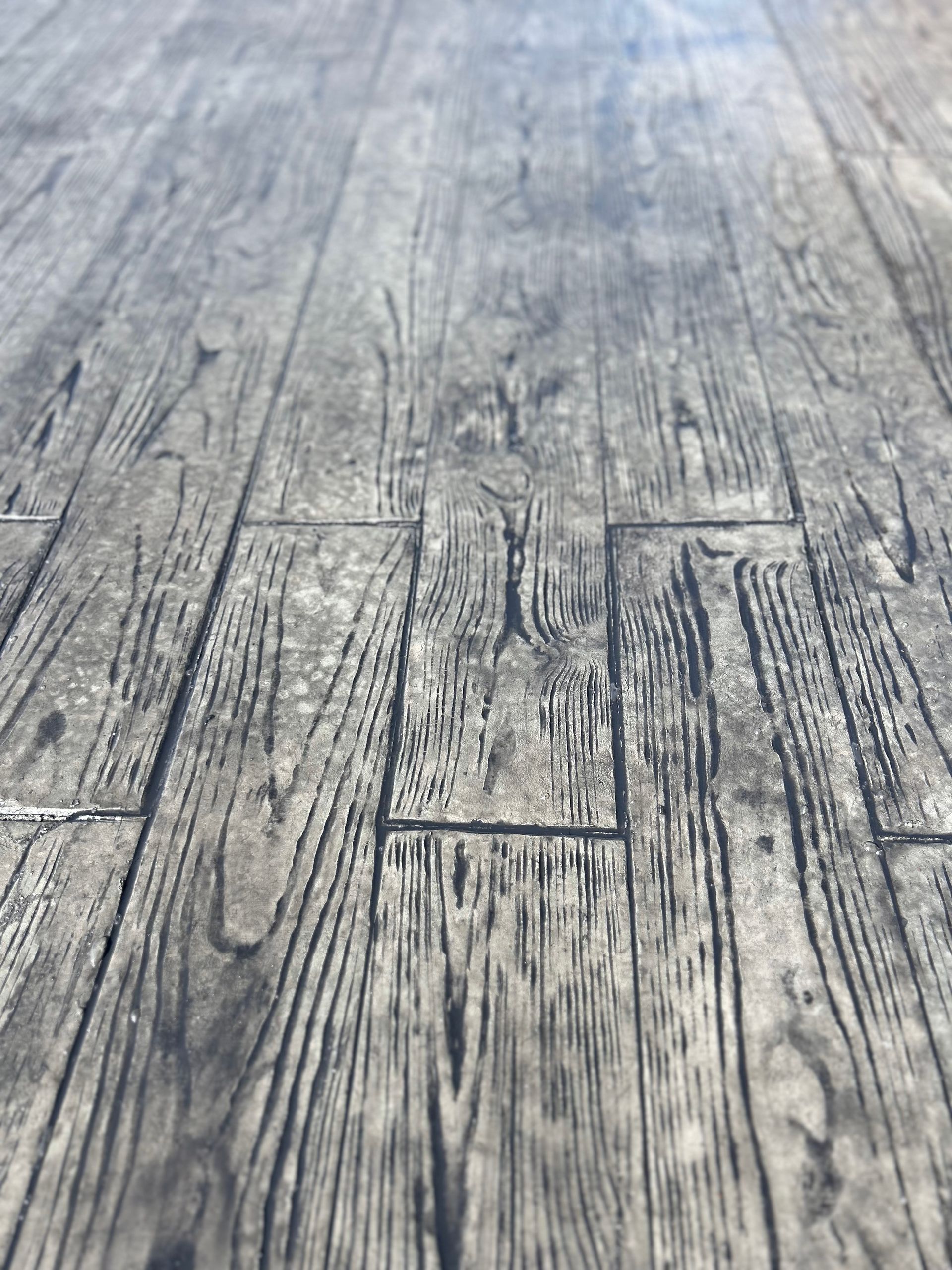 A close up of a concrete floor that looks like wood.