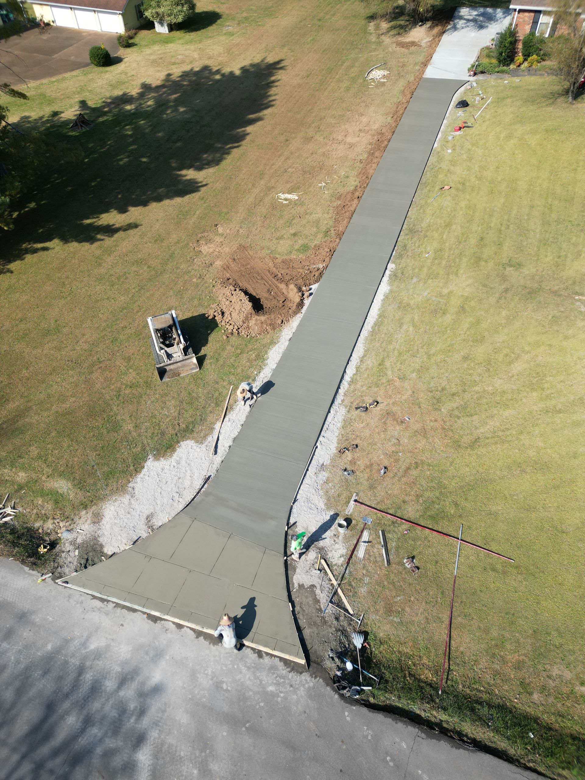 An aerial view of a concrete driveway being built.