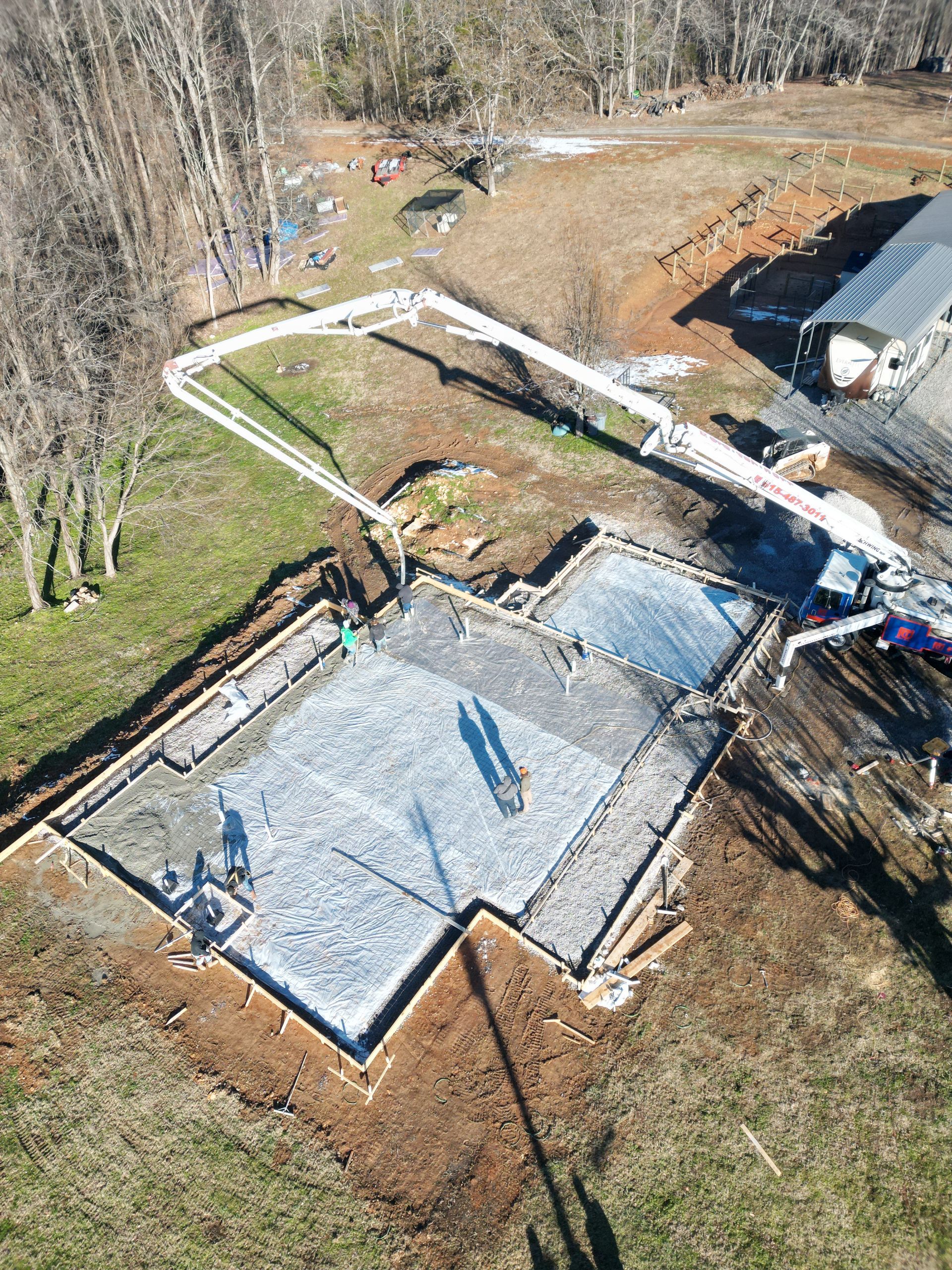 An aerial view of a concrete base for a house under construction.