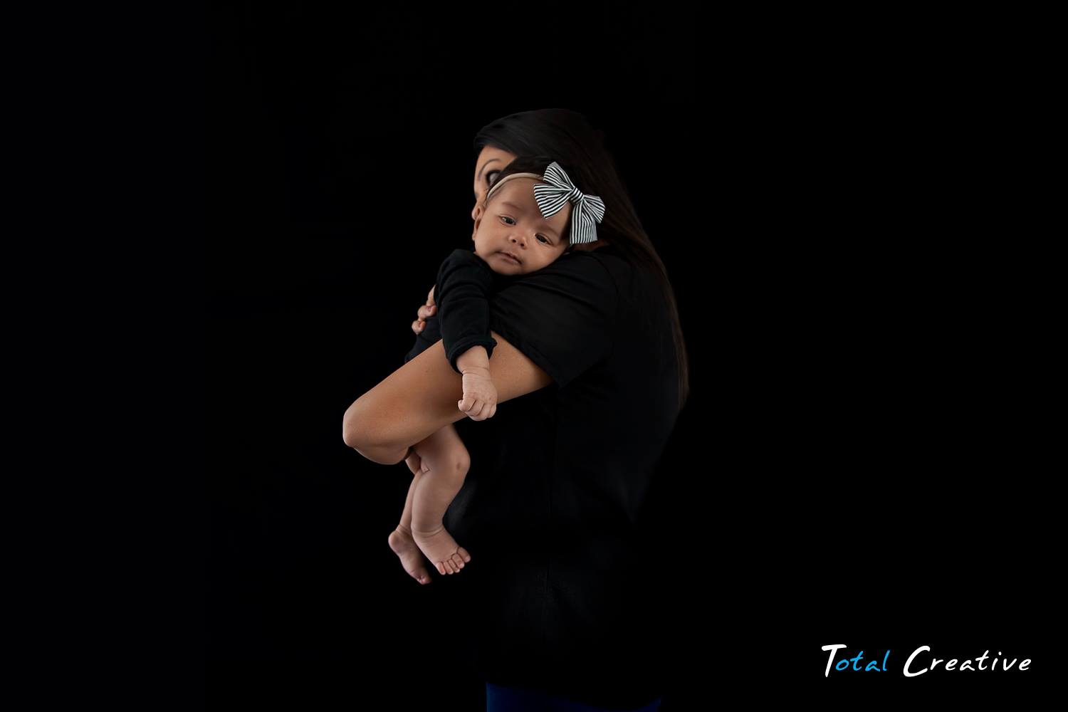 Relaxed home family photography session. Parent and new born baby photographer.
