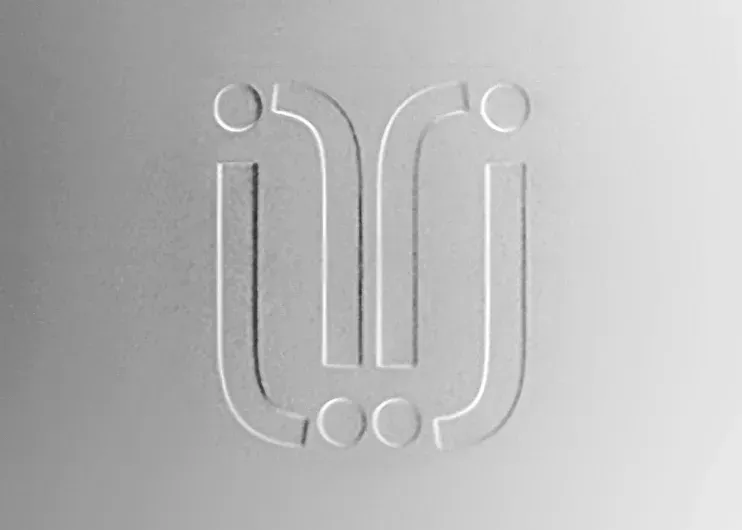 Embossed white and print Julinda's logo symbol at Total Creative