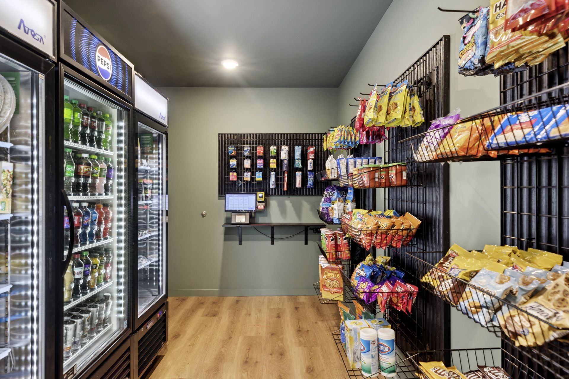 On-site amenity room with vending refrigerators and snack shelves for residents at Esox House in St. Paul, MN.