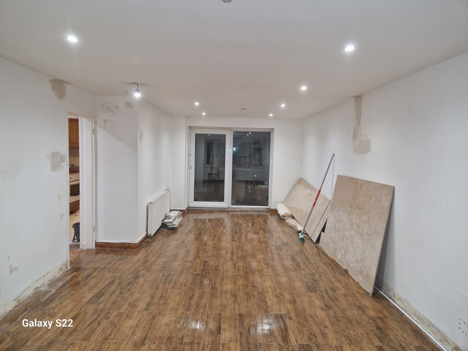 A picture of a kitchen/diner painted white with new flooring by Signature Painters and Decorators York