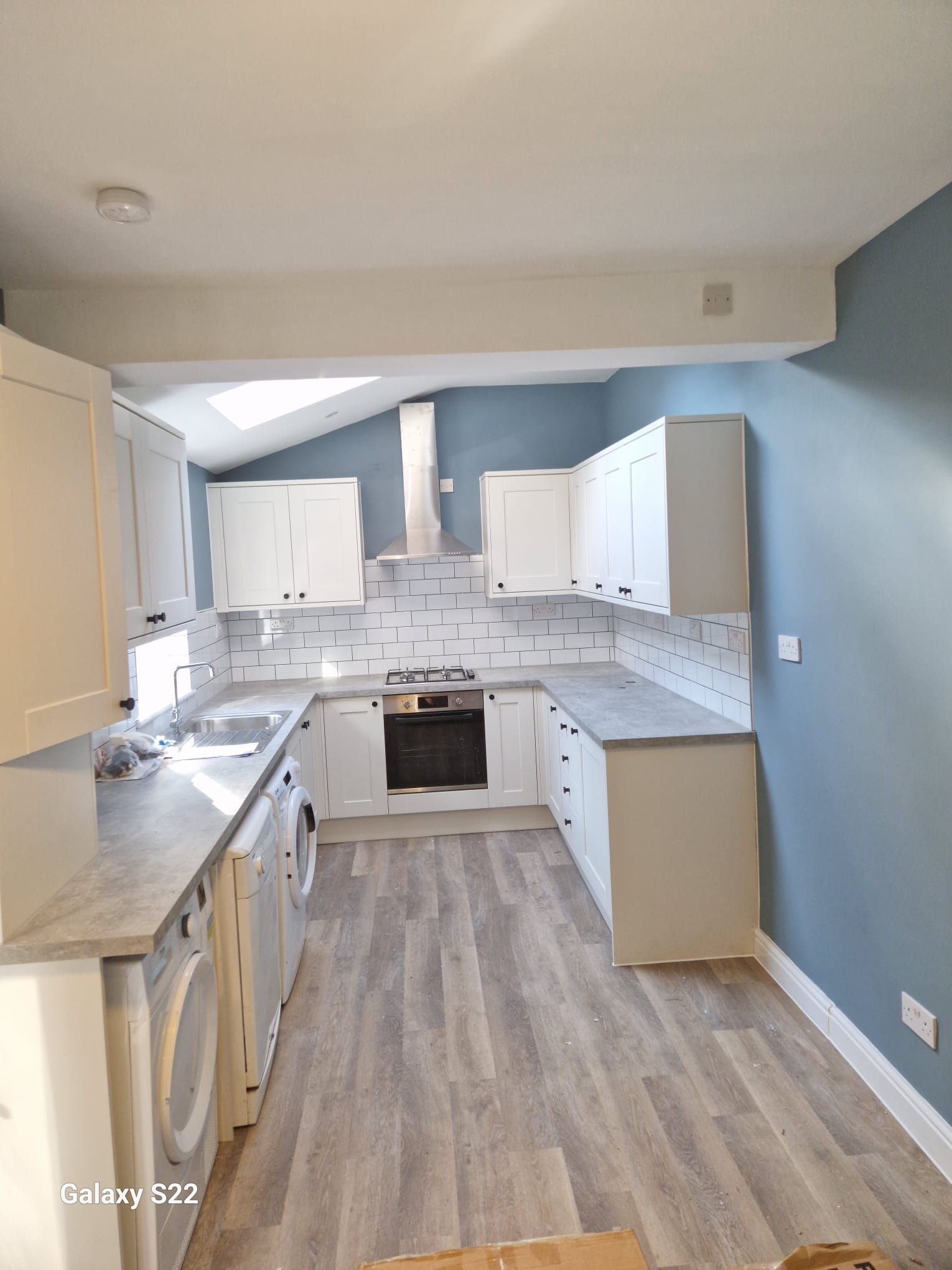 A picture of a kitchen painted baby blue at a property in Fairway Drive by Signature Painters and Decorators York