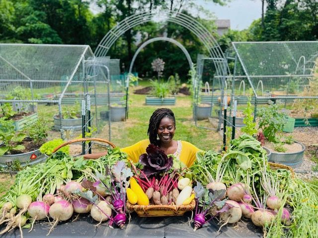Alethea sitting in a garden.