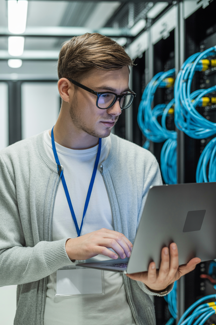 Houston IT technician reviewing server data at Quinn Technology Solutions.
