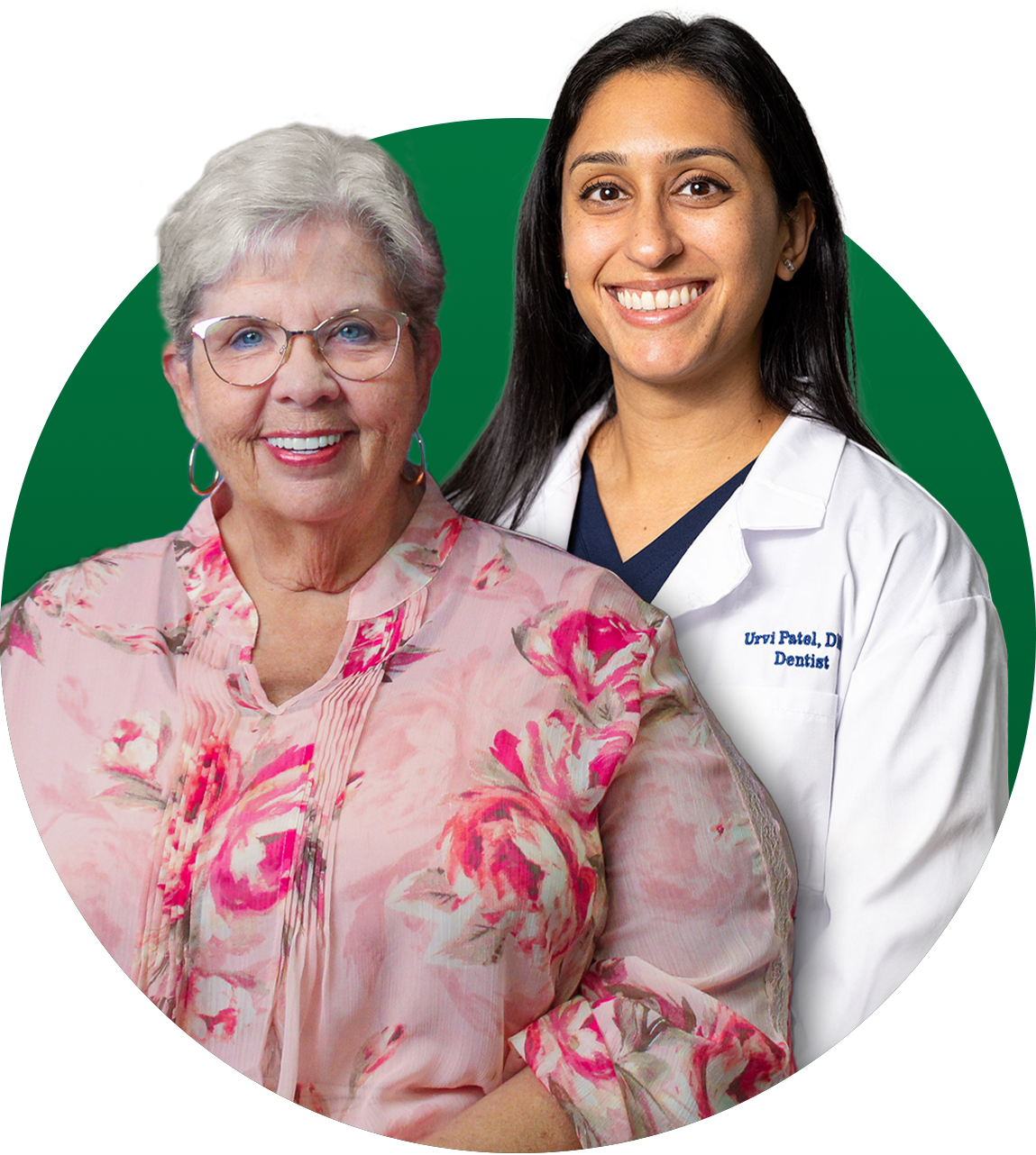 Woman with glasses smiles next to a woman in a lab coat, both in front of a green background.