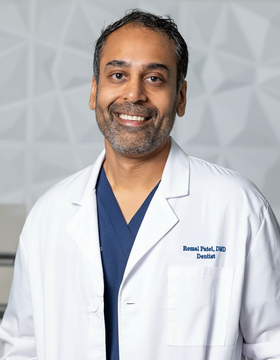 Man in white lab coat smiles; text