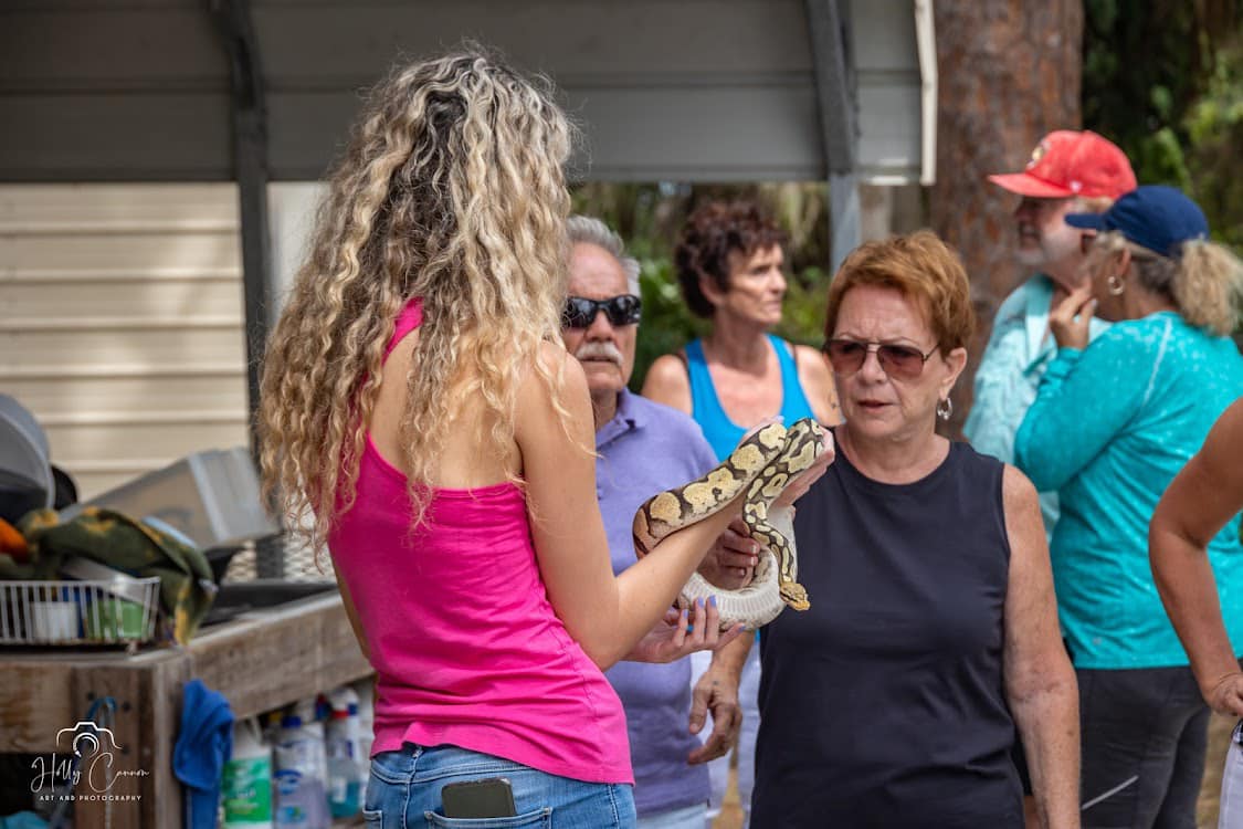 Staff member holding a ball python