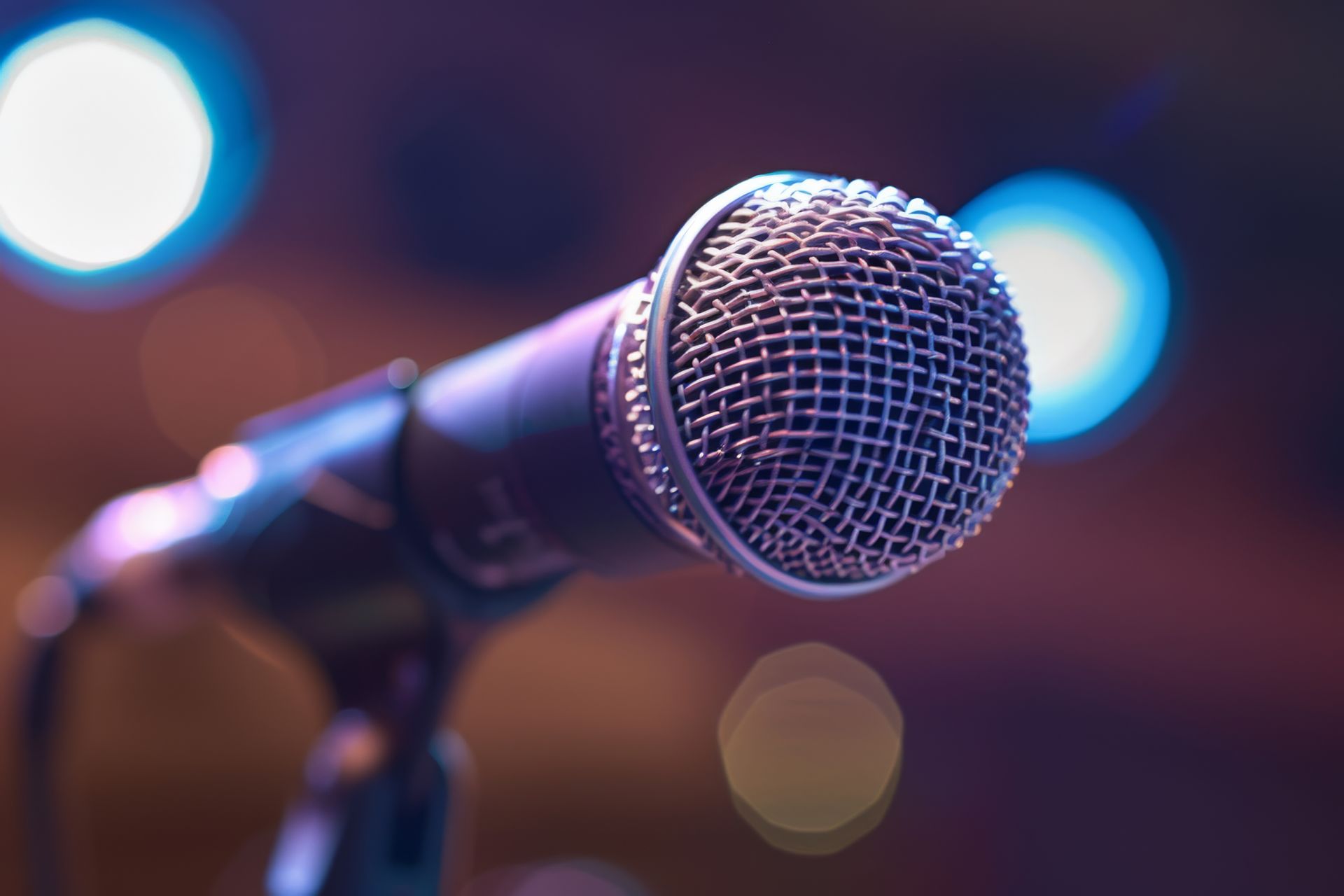 A close up of a microphone on a stand on a stage.