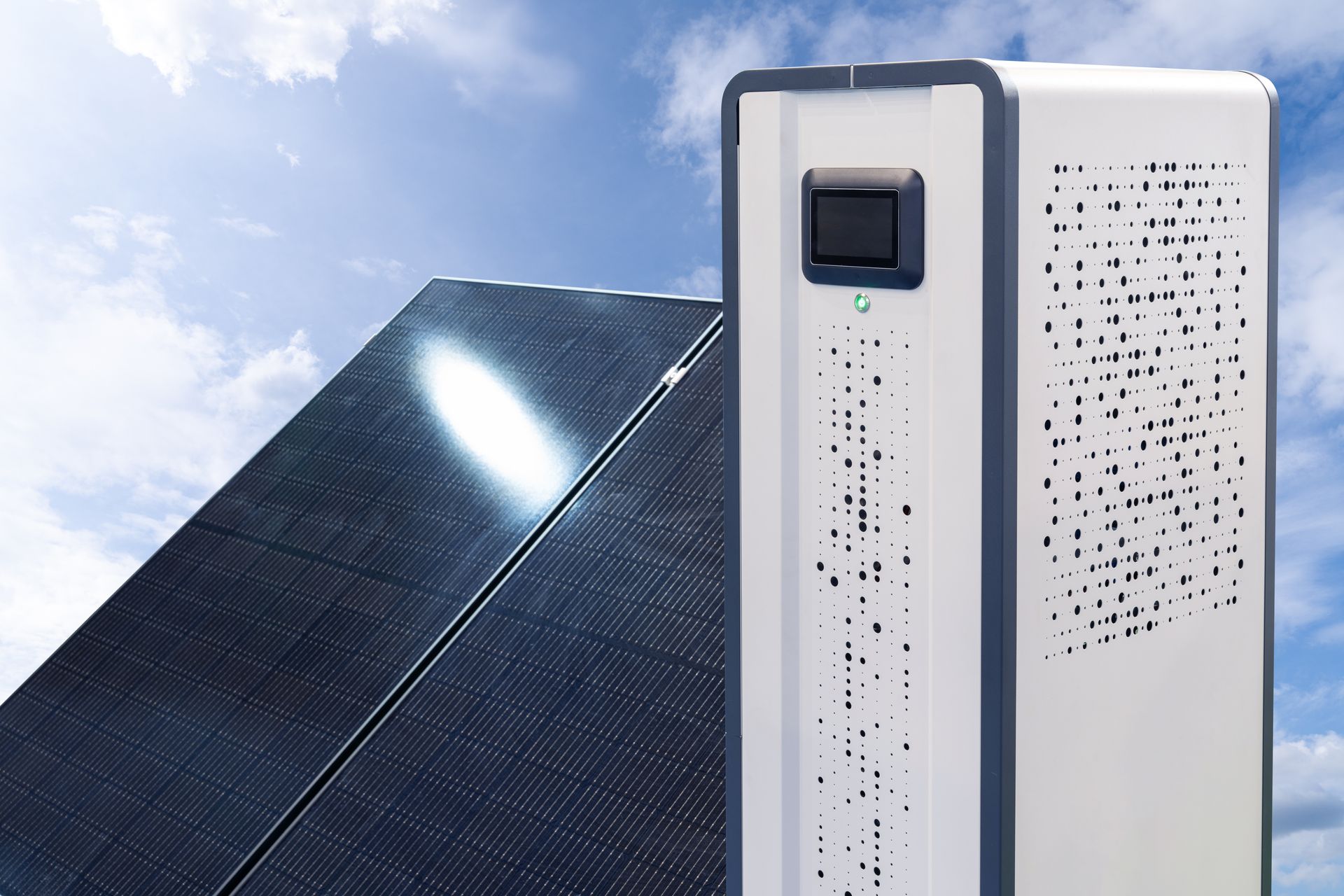 A white box is sitting next to a solar panel