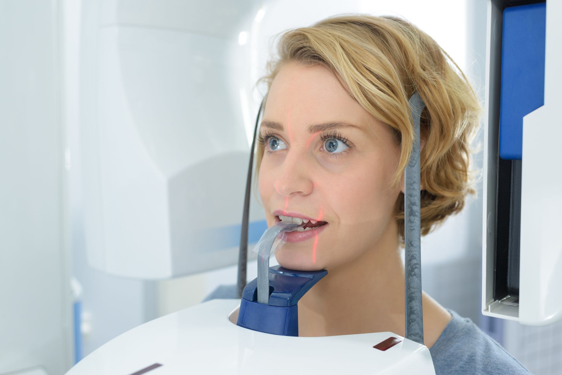 A close-up of a woman having a dental x-ray.
