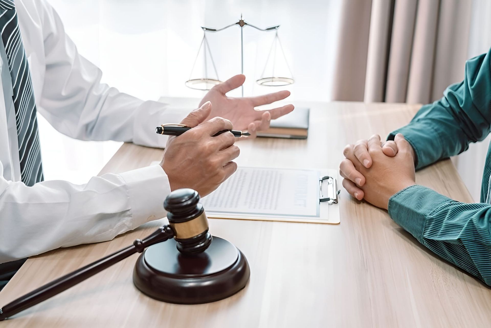 A Lawyer Is Sitting At A Table Talking To A Client — De Silva Hebron In Darwin City, NT