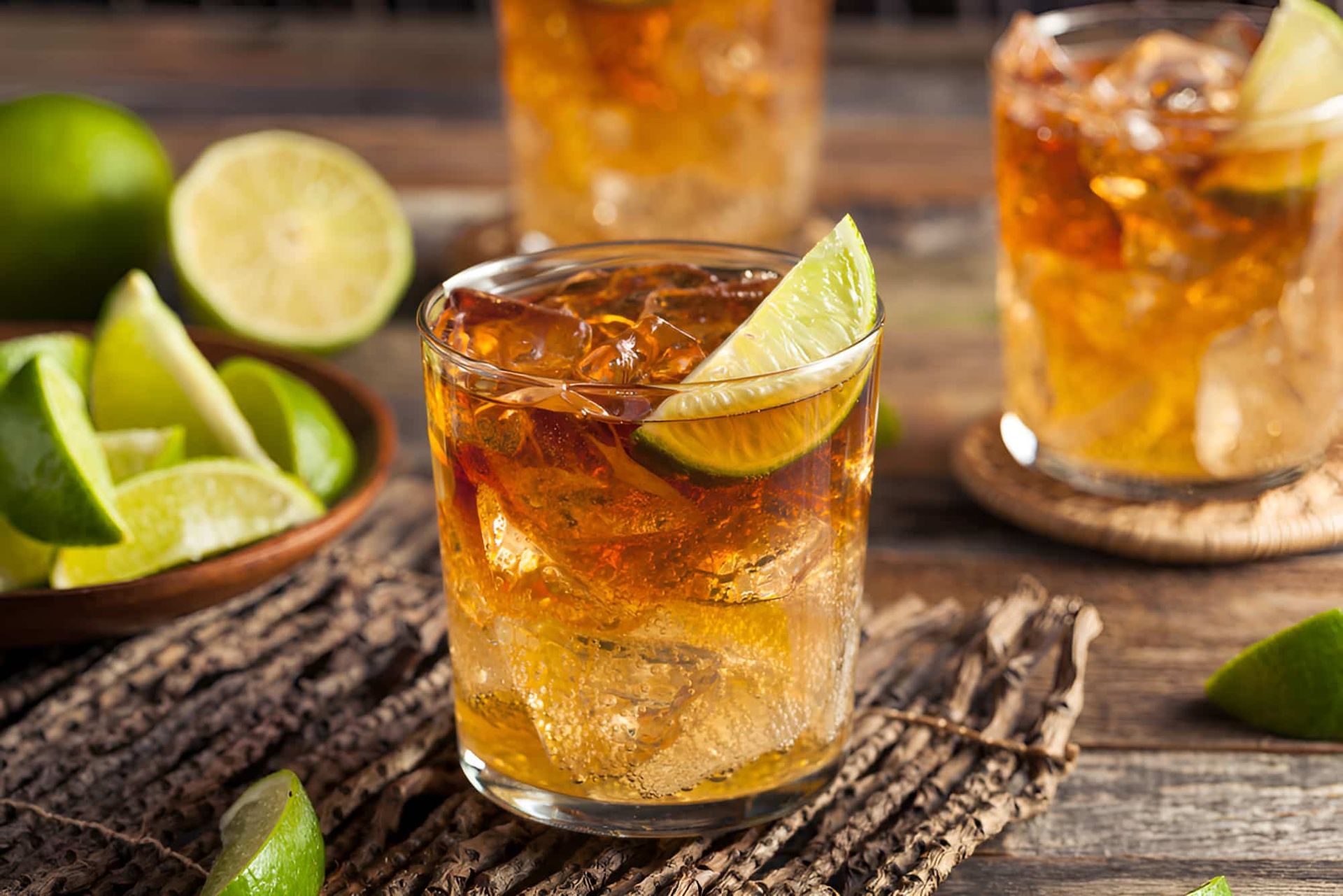Three Glasses Of Iced Tea With Limes On A Wooden Table — De Silva Hebron In Darwin City, NT