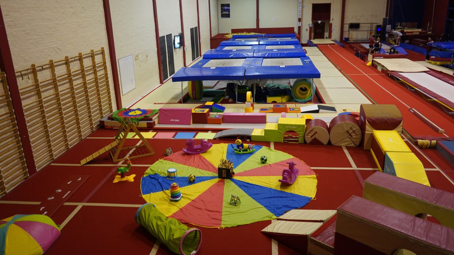 A large gym with a lot of toys on the floor