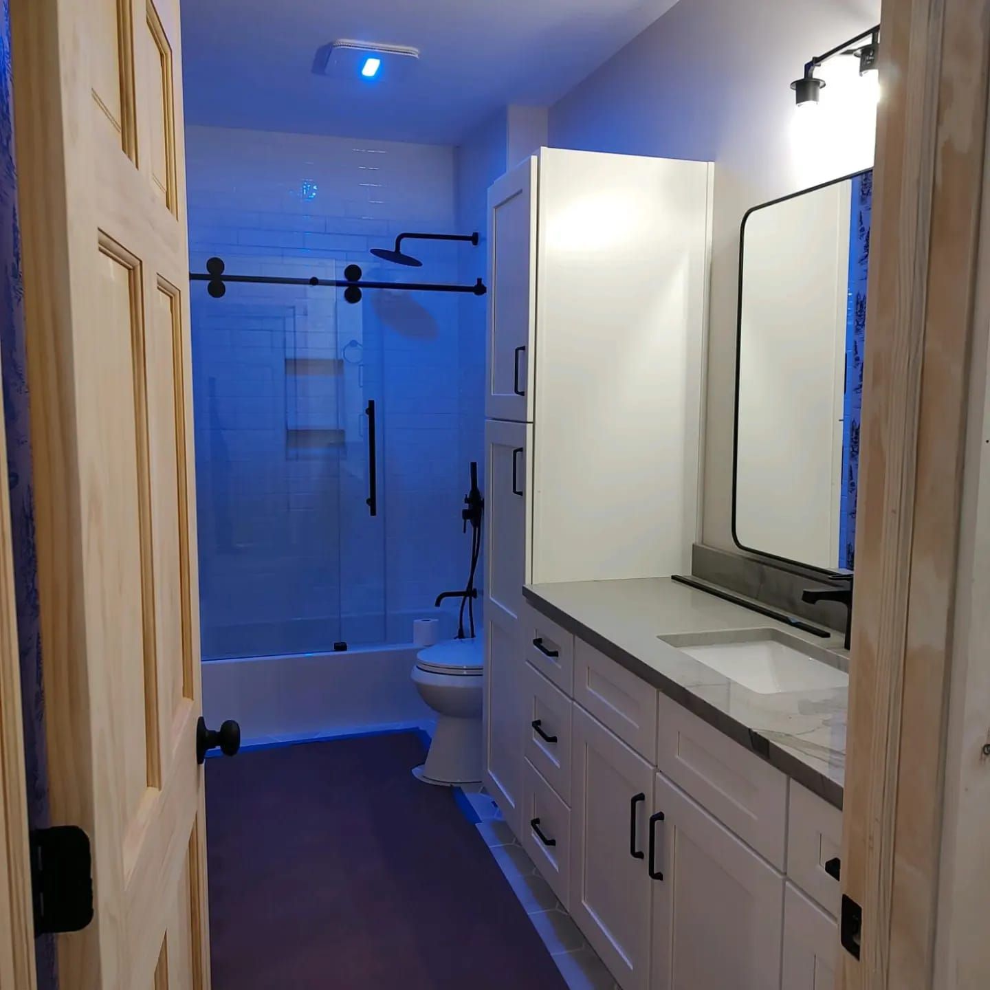 A bathroom with a toilet a sink and a mirror