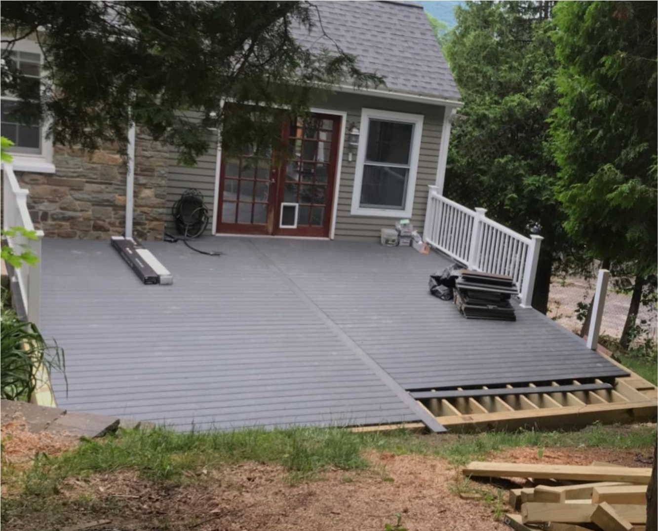 A deck is being built in front of a house.