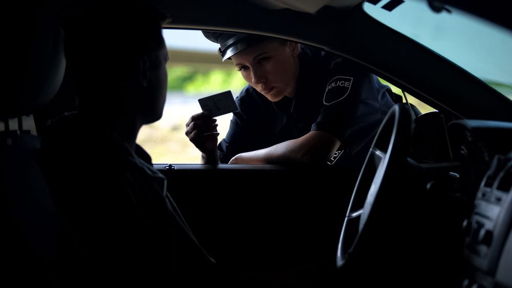 A Police Officer Is Talking To A Man — Clarence Valley Legal In Grafton, NSW