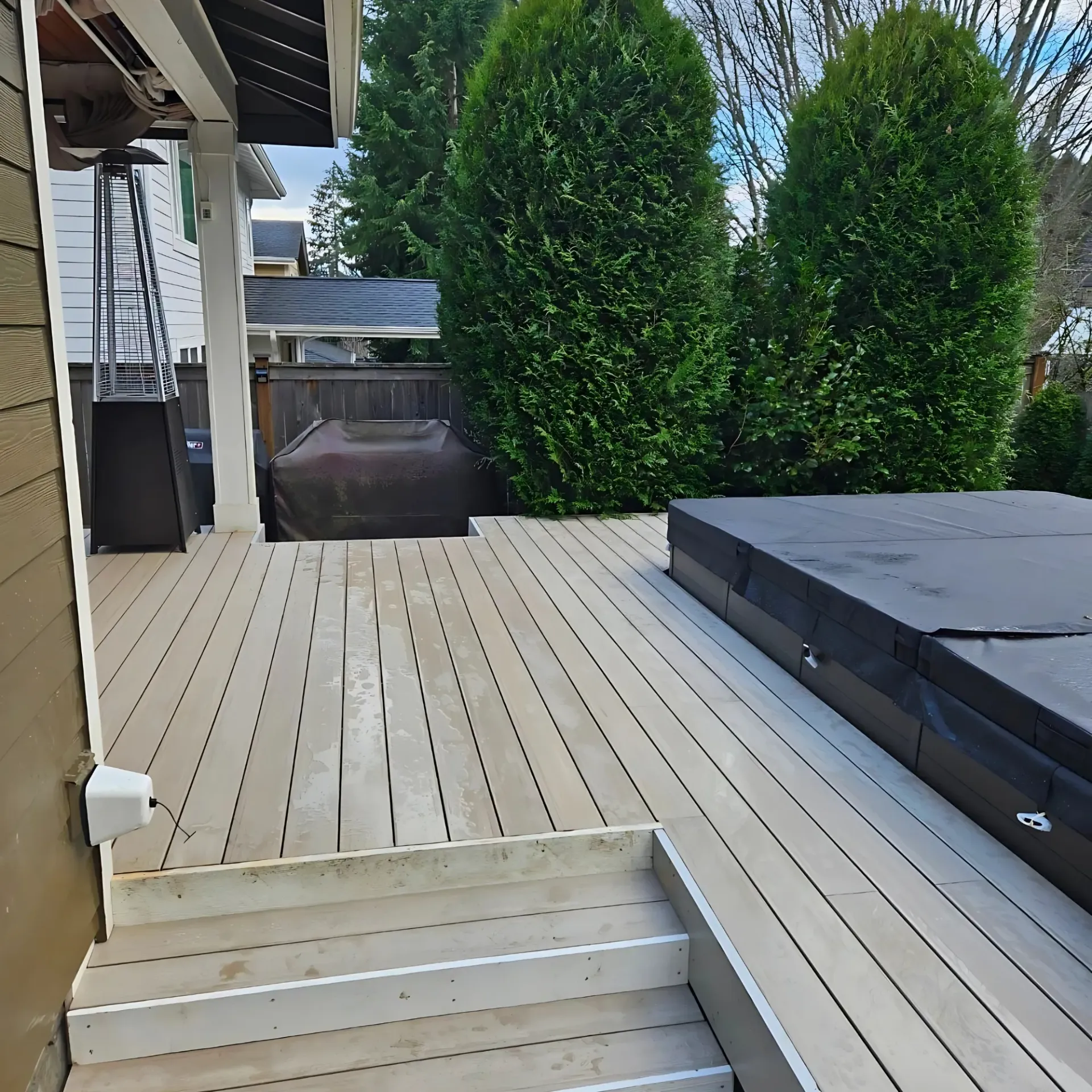 Israel Inc. - A wooden deck with stairs and a hot tub on it.