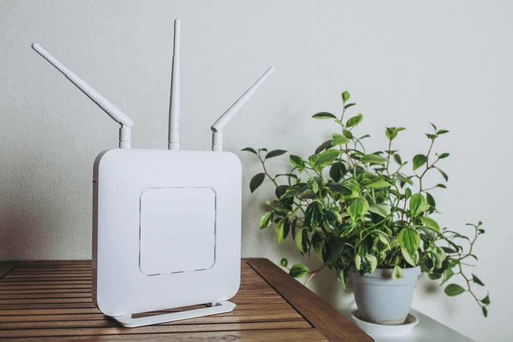 A White Router is Sitting on a Wooden Table — A1 Antenna Doctor In Port Macquarie, NSW