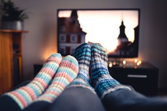 Two Pairs of Socks Are Laying on A Couch in Front of A Television — A1 Antenna Doctor In Wauchope, NSW