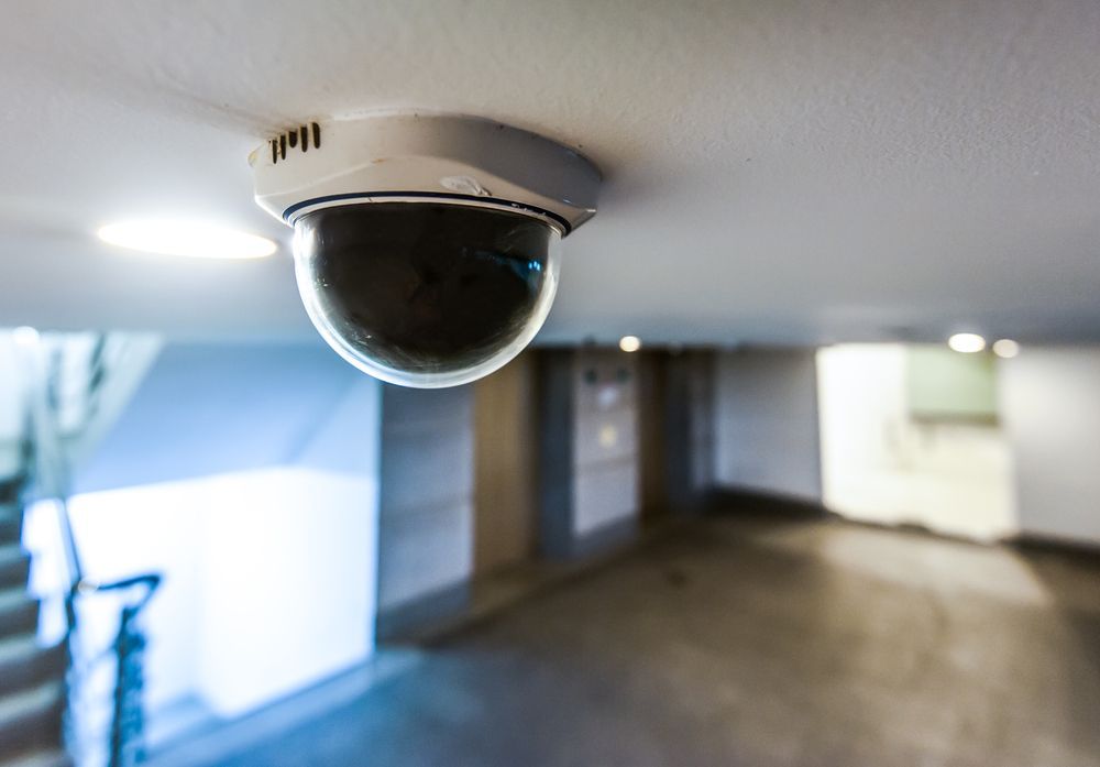 A Security Camera Is Hanging from The Ceiling of A Building — A1 Antenna Doctor In Port Macquarie, NSW