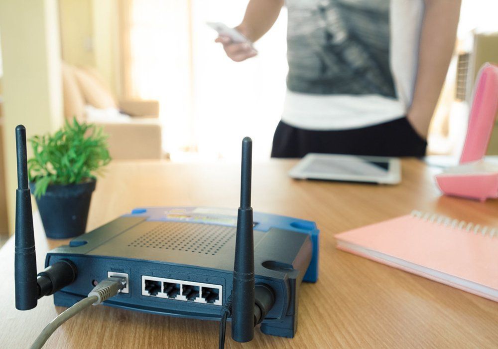 A Person is Standing in Front of a Router on a Table — A1 Antenna Doctor In Port Macquarie, NSW