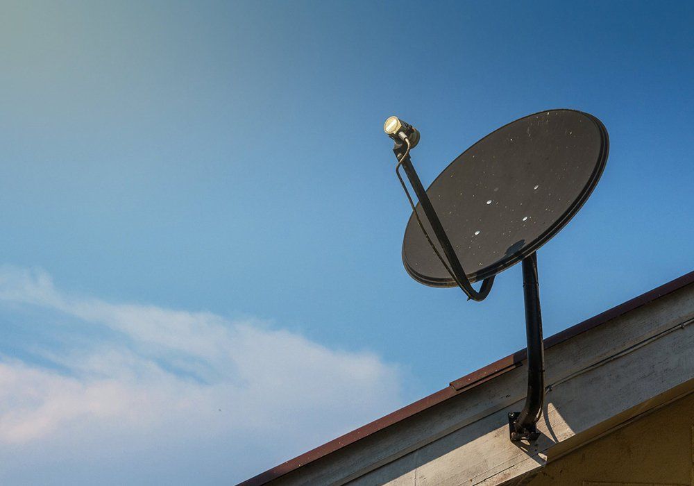 A Satellite Dish Is Mounted on The Roof of A Building — A1 Antenna Doctor In Port Macquarie, NSW