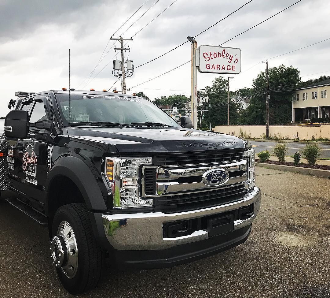 Black tow truck parked in front of 