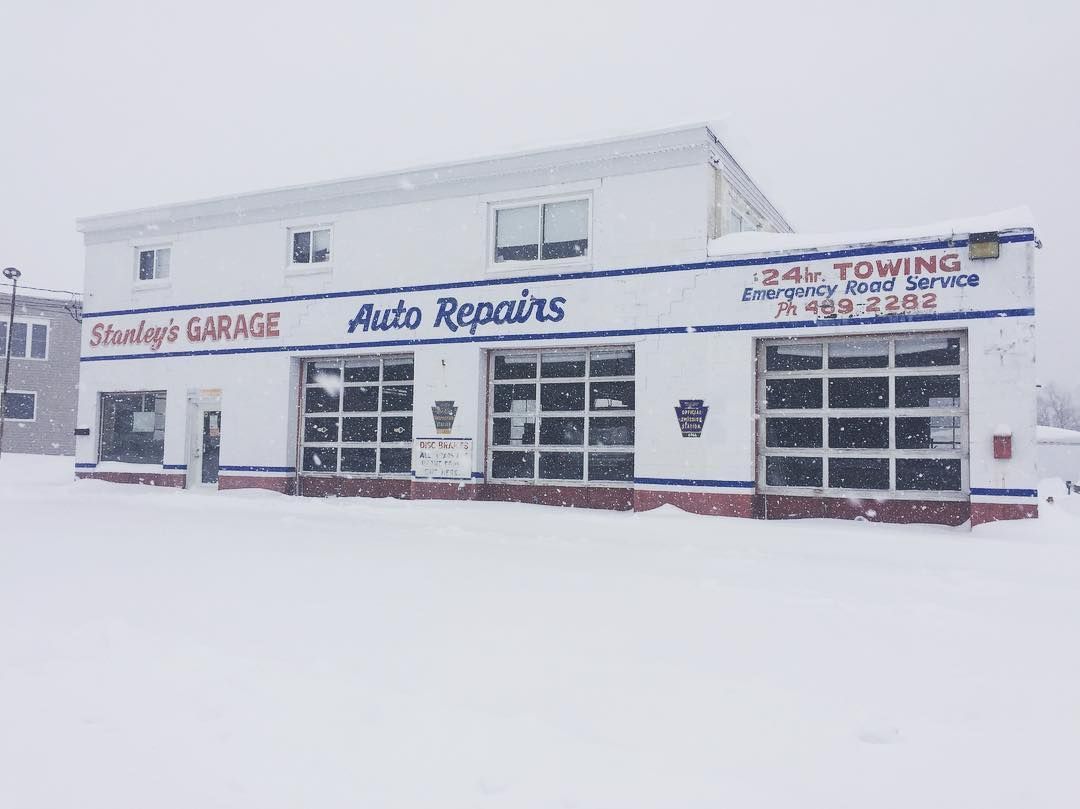 Stanley's Garage, auto repair shop, exterior view, with snow falling.