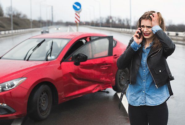 woman with red car after crash