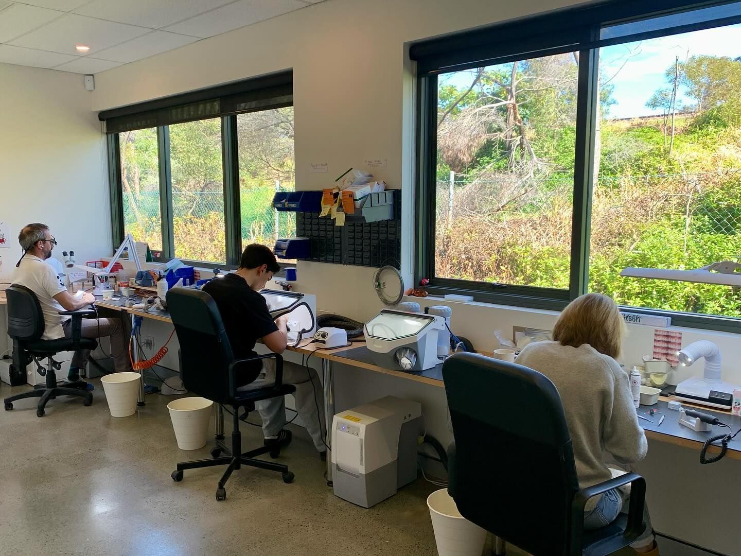 Three People Work at Lab Benches Near Windows — AB Esthetic Dental Laboratory in Robina, QLD