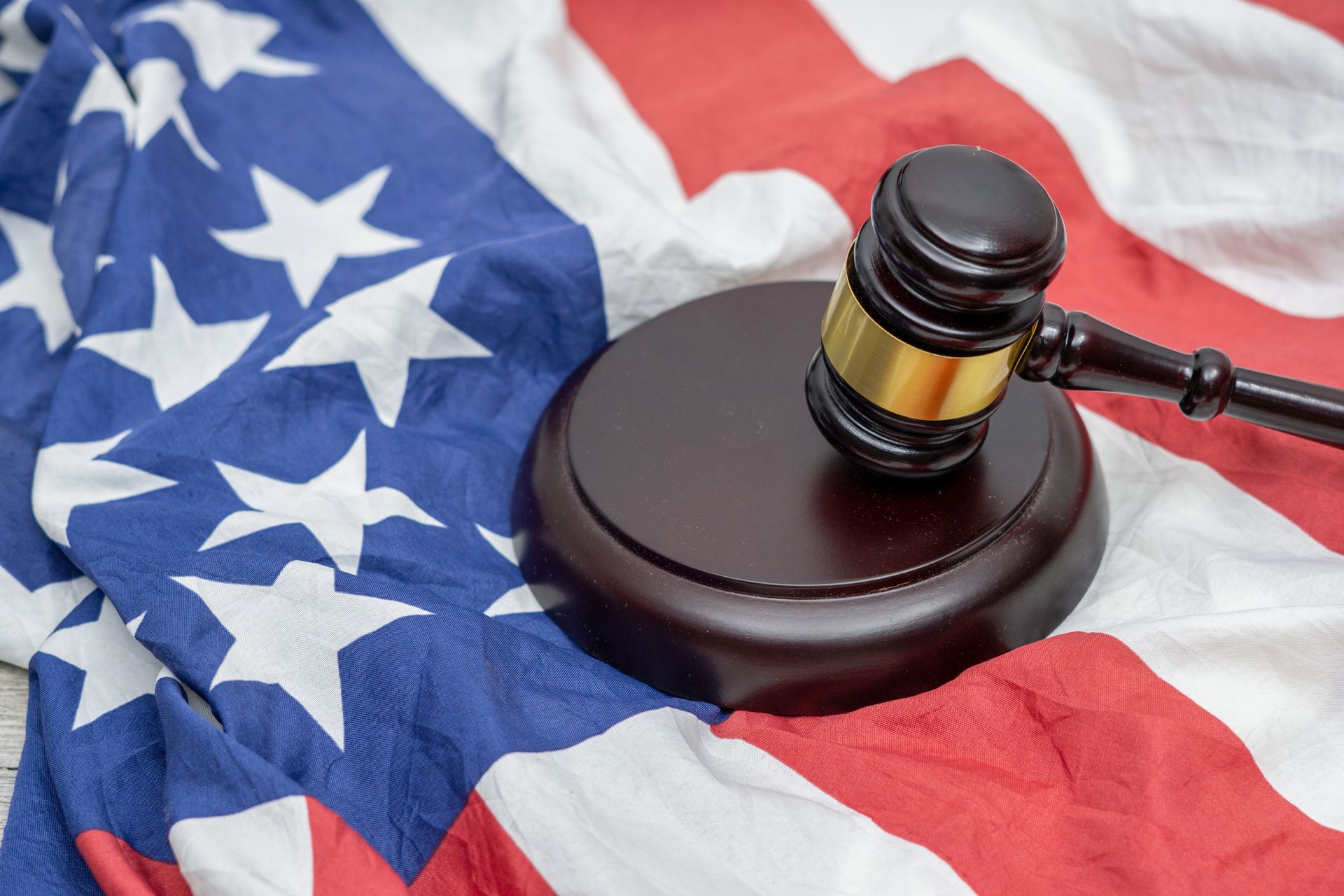 A Judge 's Gavel Is Sitting on Top of An American Flag.