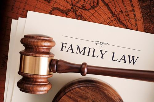 A wooden gavel is sitting on top of a piece of paper that says family law.