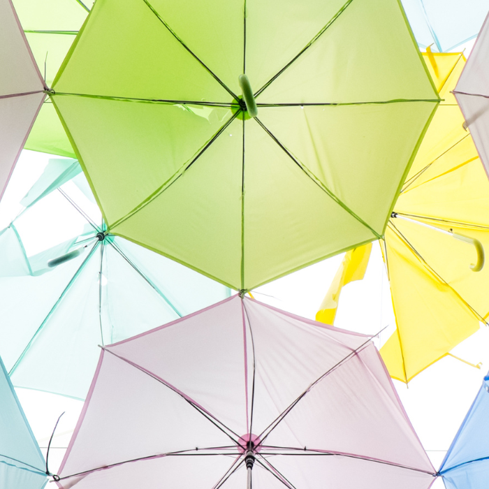 a bunch of colorful umbrellas are stacked on top of each other