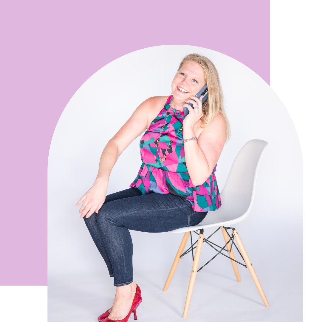 A woman is sitting in a chair talking on a cell phone