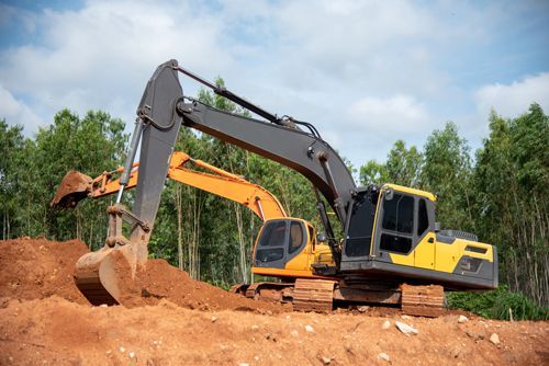 Two Excavators Are Working On A Dirt Field - Millville, CA - Concrete Construction Excavating Inc.