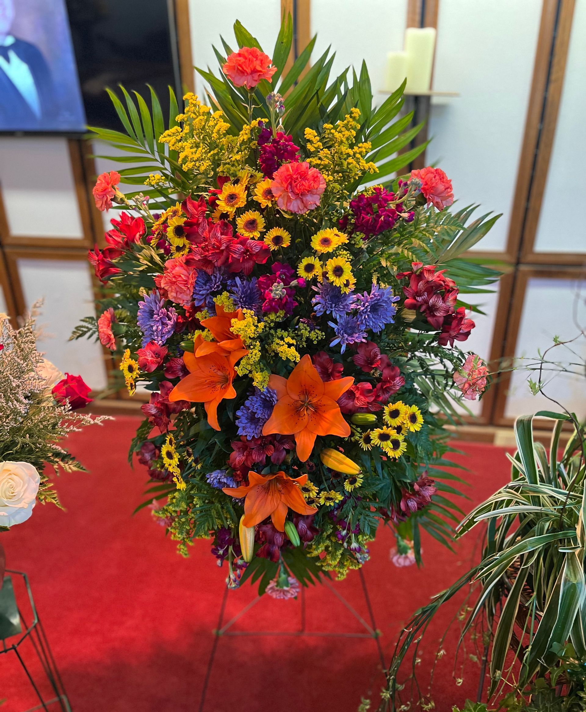 A bunch of vases filled with flowers are sitting in a refrigerator.