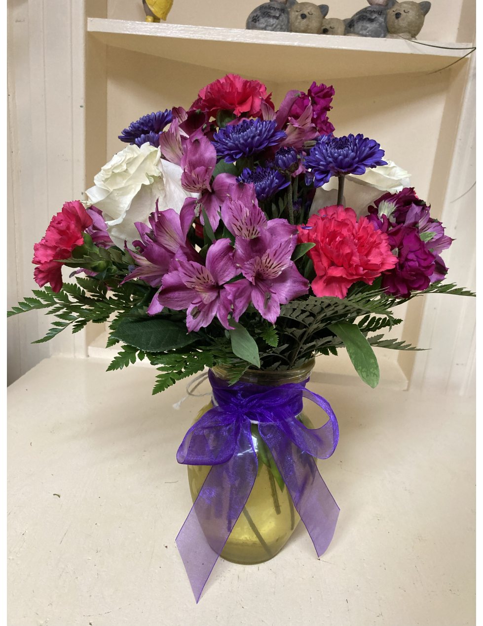 A bunch of colorful flowers in a vase on a table