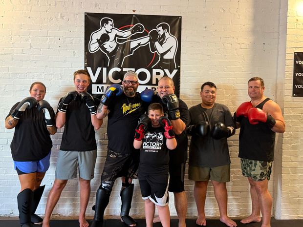 Group of people in boxing gear posing. Group of people in boxing gear posing.
