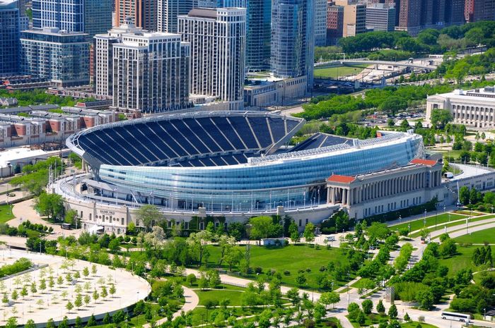 Aerial view of Soldier Field stadium in Chicago, Illinois. Buildings and green park surround the stadium.