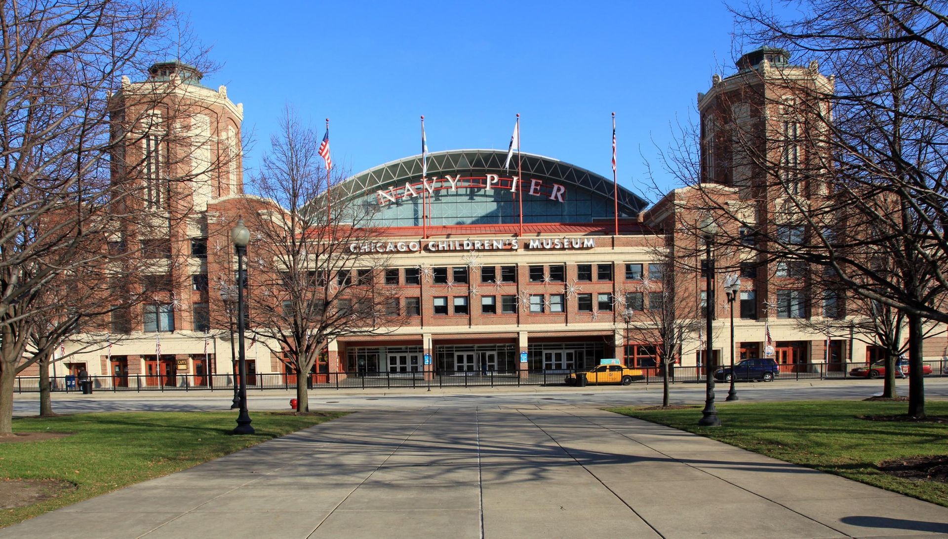 Brick-faced Huntington Center building with towers on either side, a glass dome, and a plaza in the foreground.