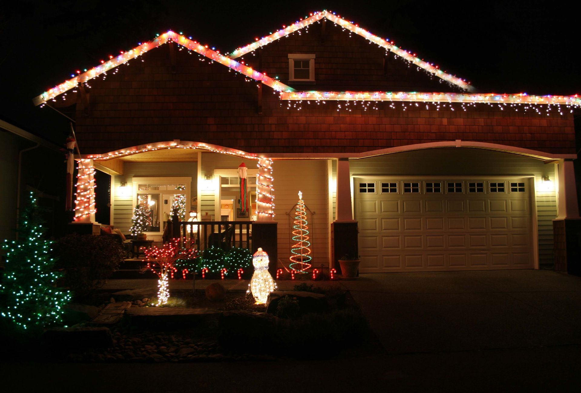 House decorated with Christmas lights at night.