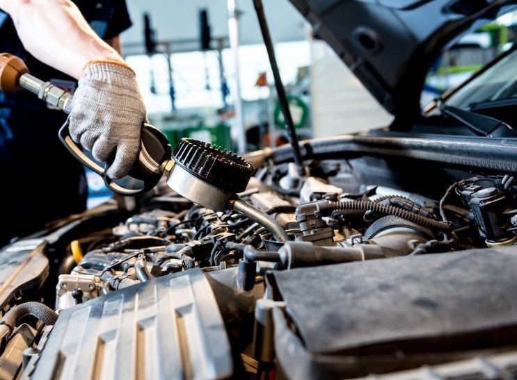 Part of car MOT service in workshop in Reading